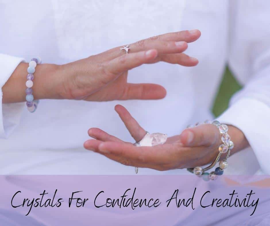 A lady holding a crystal in her hands with a text banner with the words Crystals for Confidence and Creativity
