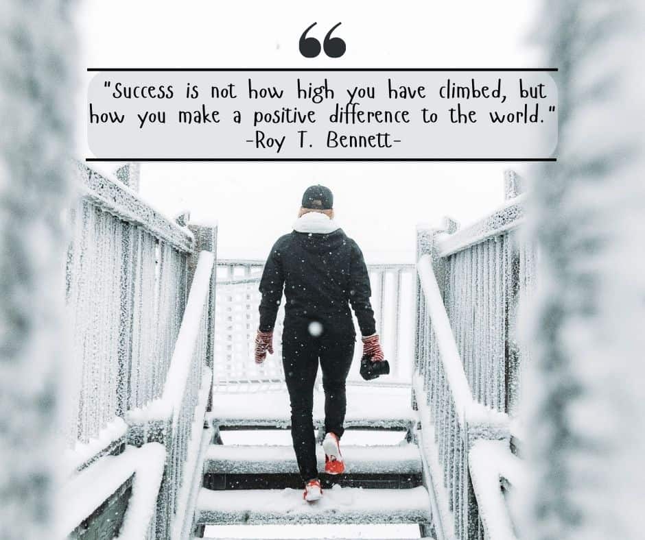 A woman walking up stairs in the snow with the quote from Roy T Bennett "Success is not how high you have climbed, but how you make a positive difference to the world."